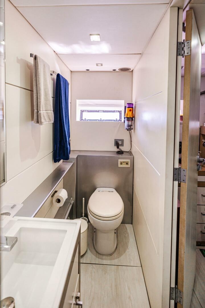 a bathroom with a toilet and sink aboard VELOCE II Yacht for Sale