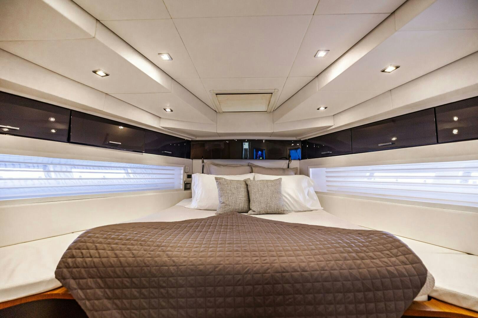 a room with a bed and a window aboard VELOCE II Yacht for Sale
