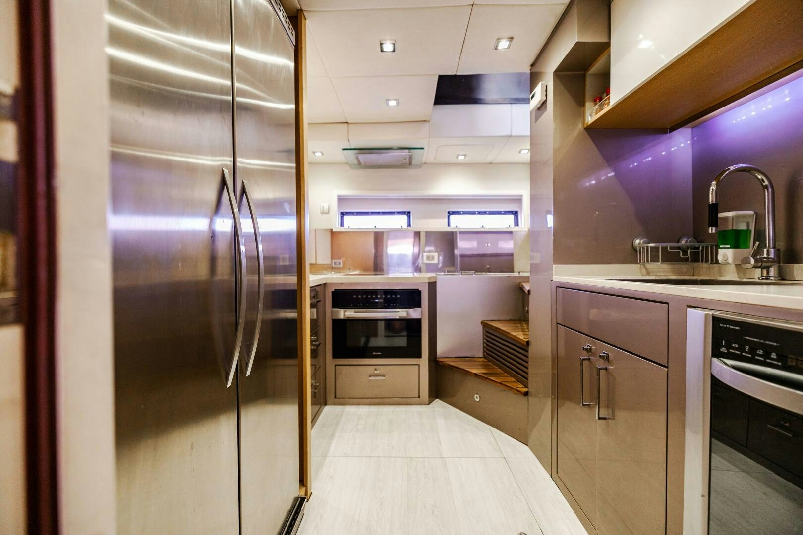 a kitchen with a refrigerator and oven aboard VELOCE II Yacht for Sale