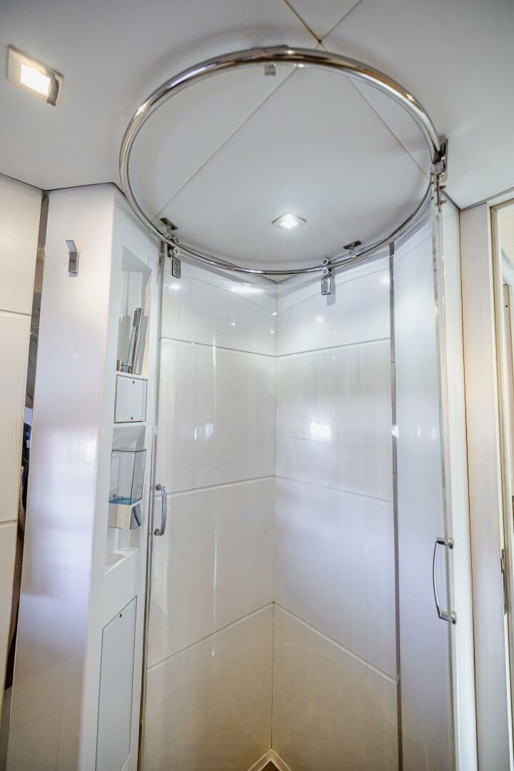 a bathroom with a round mirror aboard VELOCE II Yacht for Sale