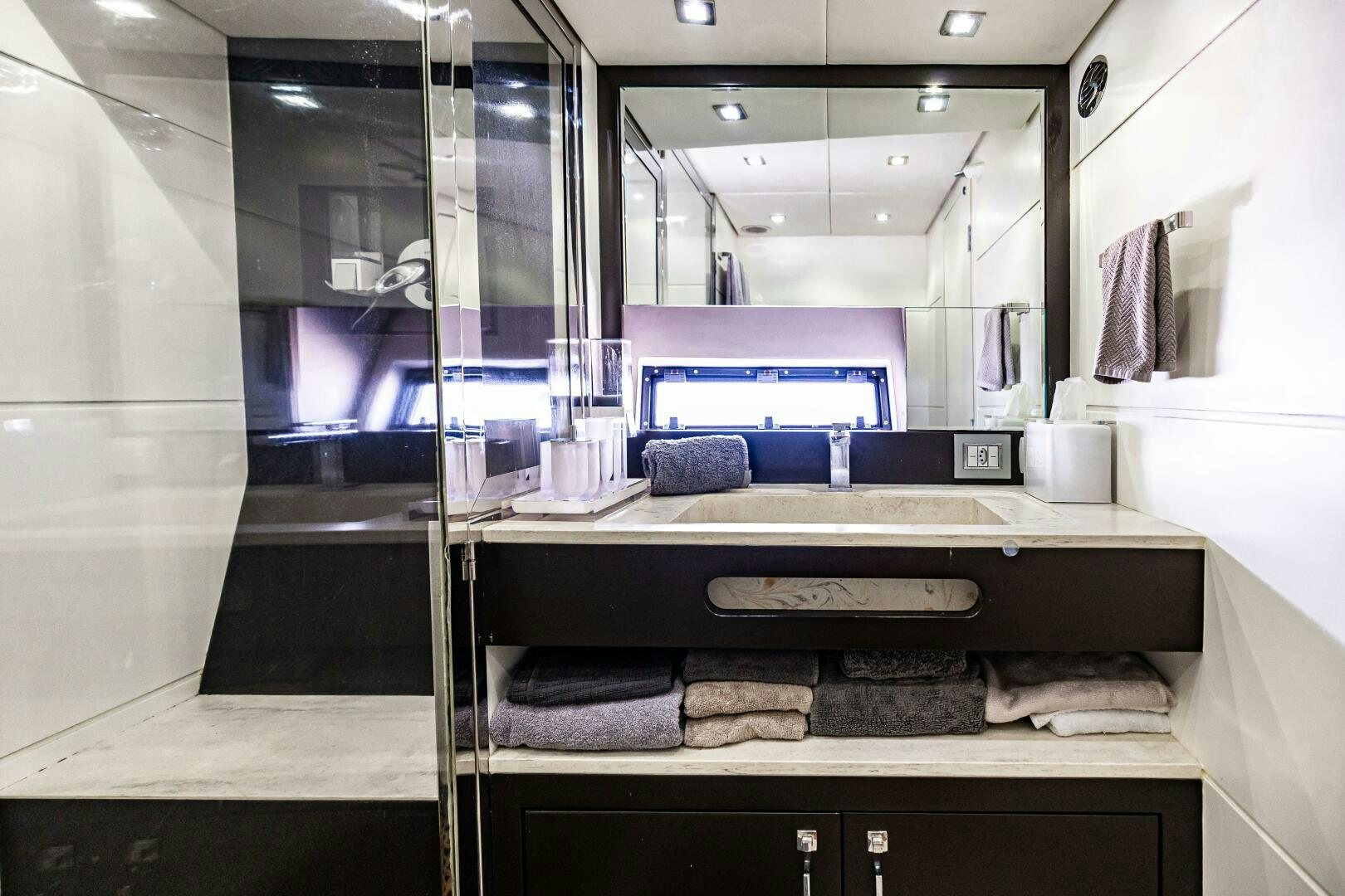 a bathroom with a large mirror aboard VELOCE II Yacht for Sale