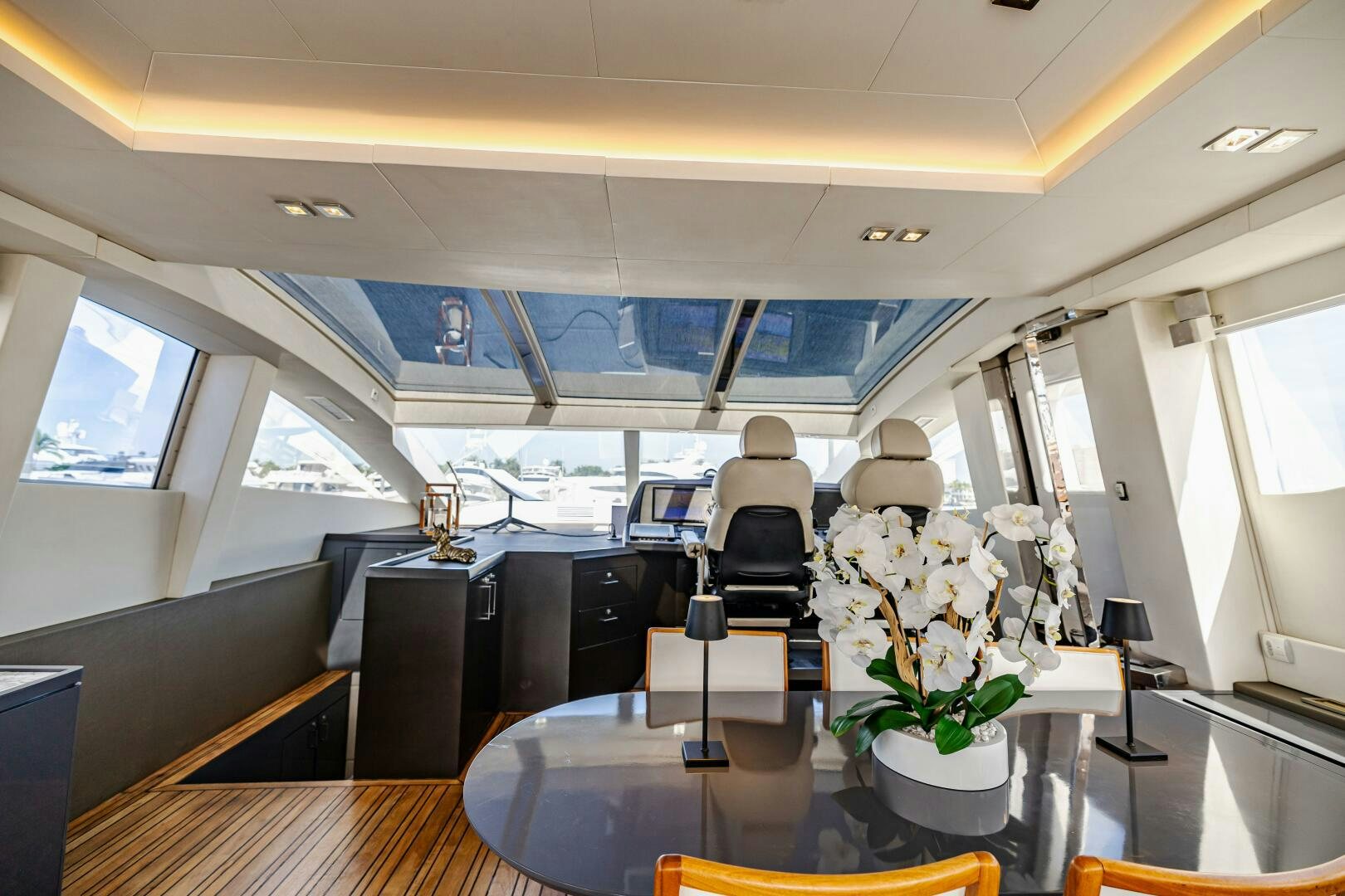 a room with a table and chairs aboard VELOCE II Yacht for Sale