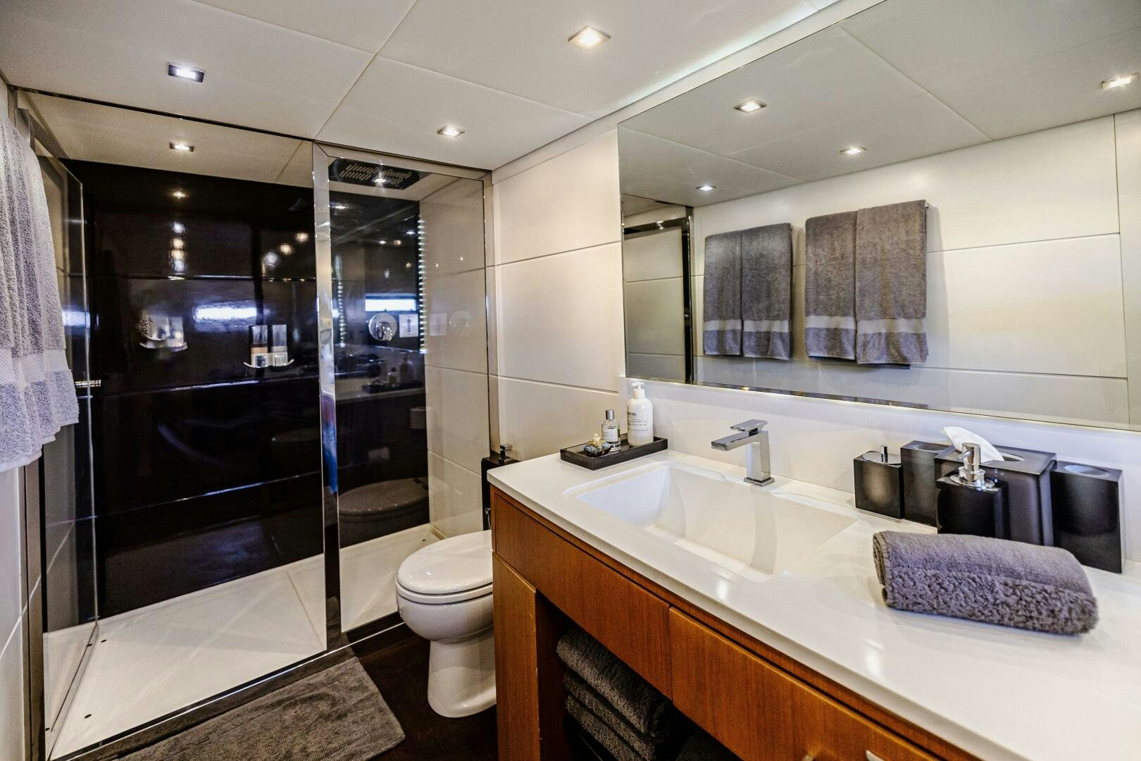 a bathroom with a glass shower aboard VELOCE II Yacht for Sale