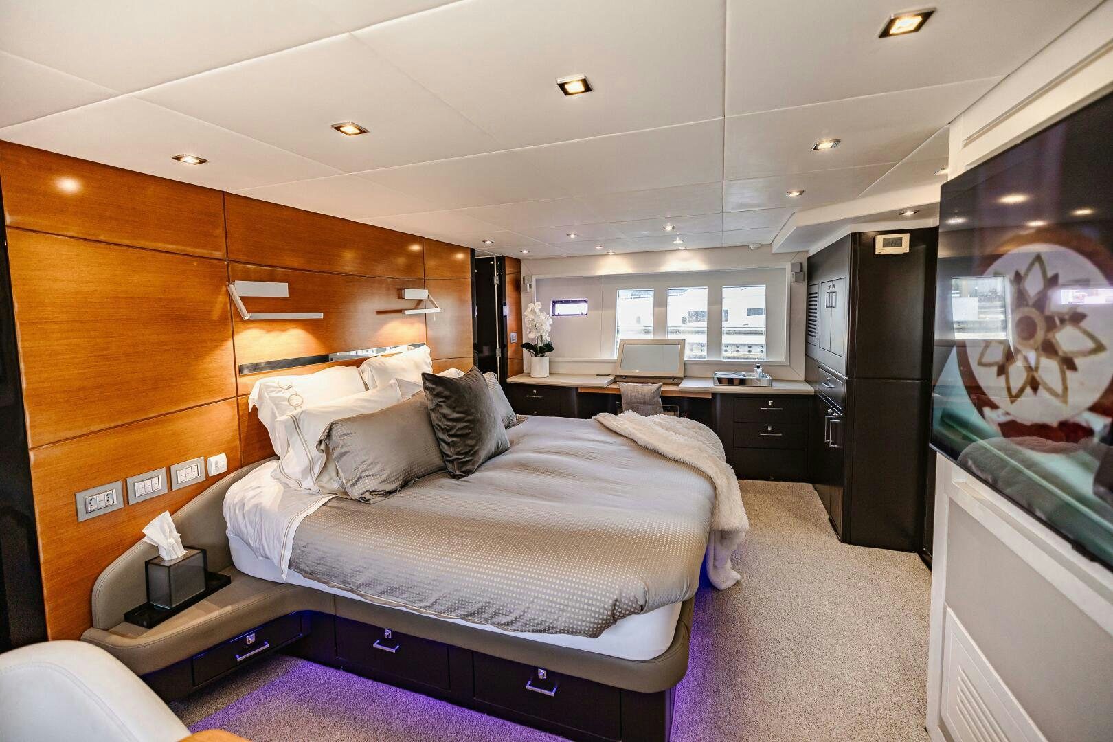 a bedroom with a bed and a tv aboard VELOCE II Yacht for Sale