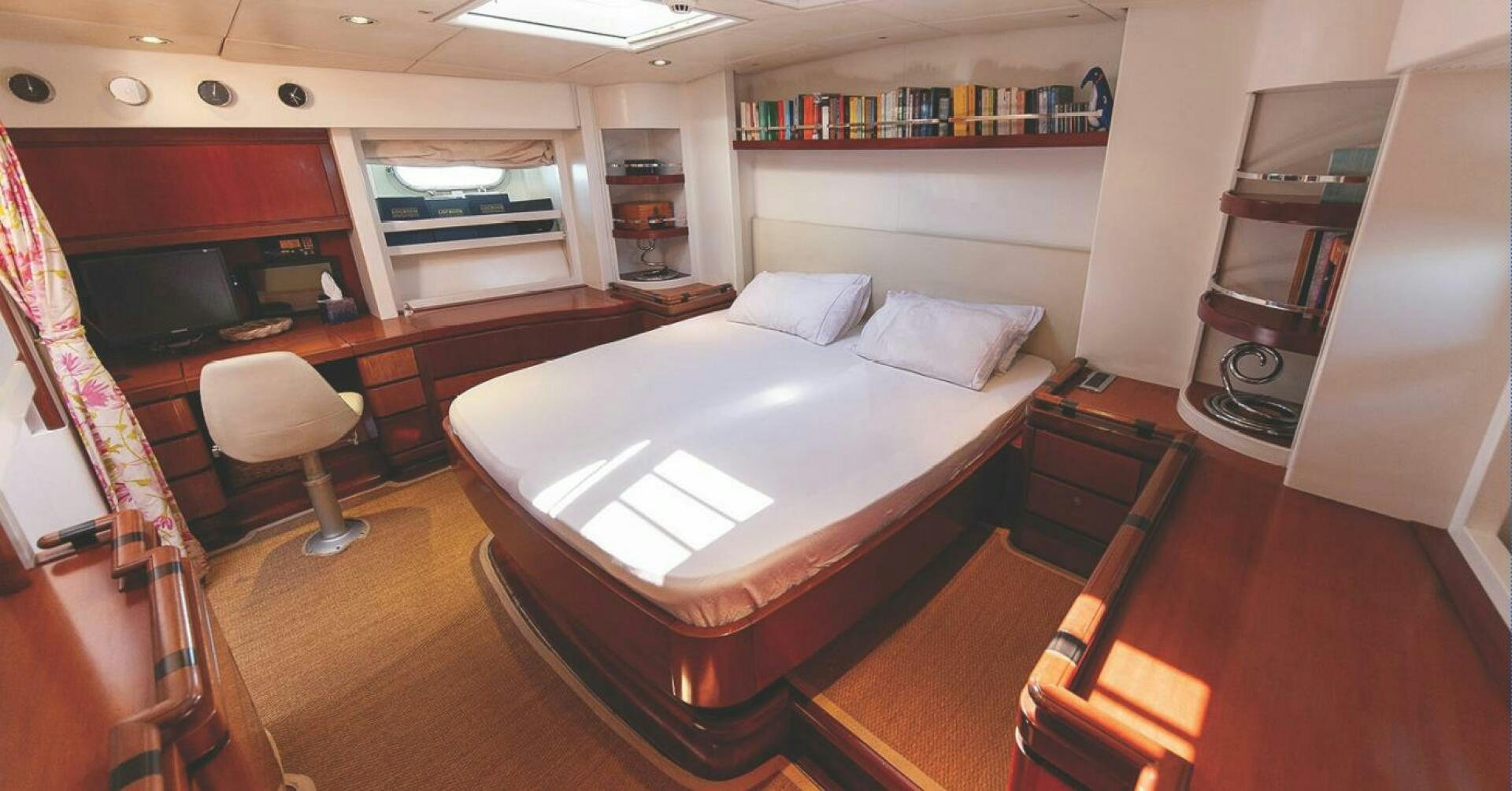 a room with a large bed and desk aboard BILLY BUDD Yacht for Sale