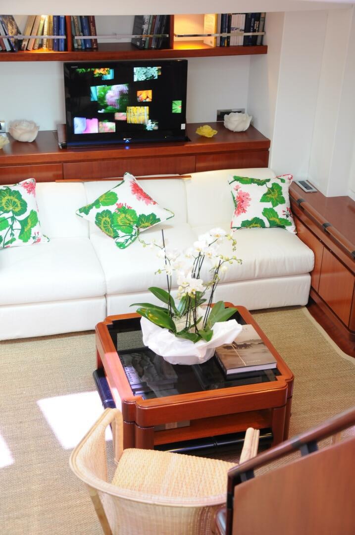 a living room with a couch and a television aboard BILLY BUDD Yacht for Sale