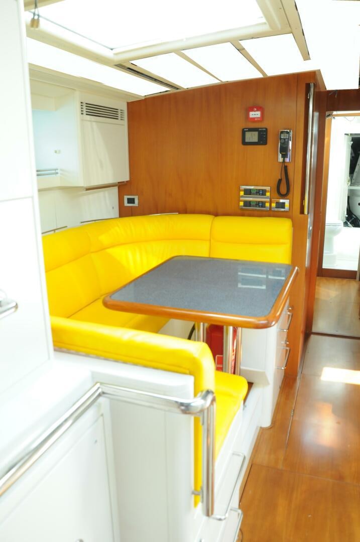 a yellow couch in a room aboard BILLY BUDD Yacht for Sale