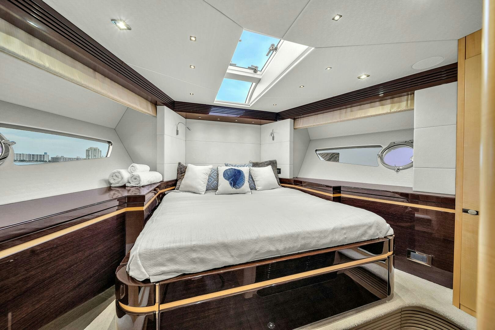 a room with a bed and a window aboard GEM Yacht for Sale