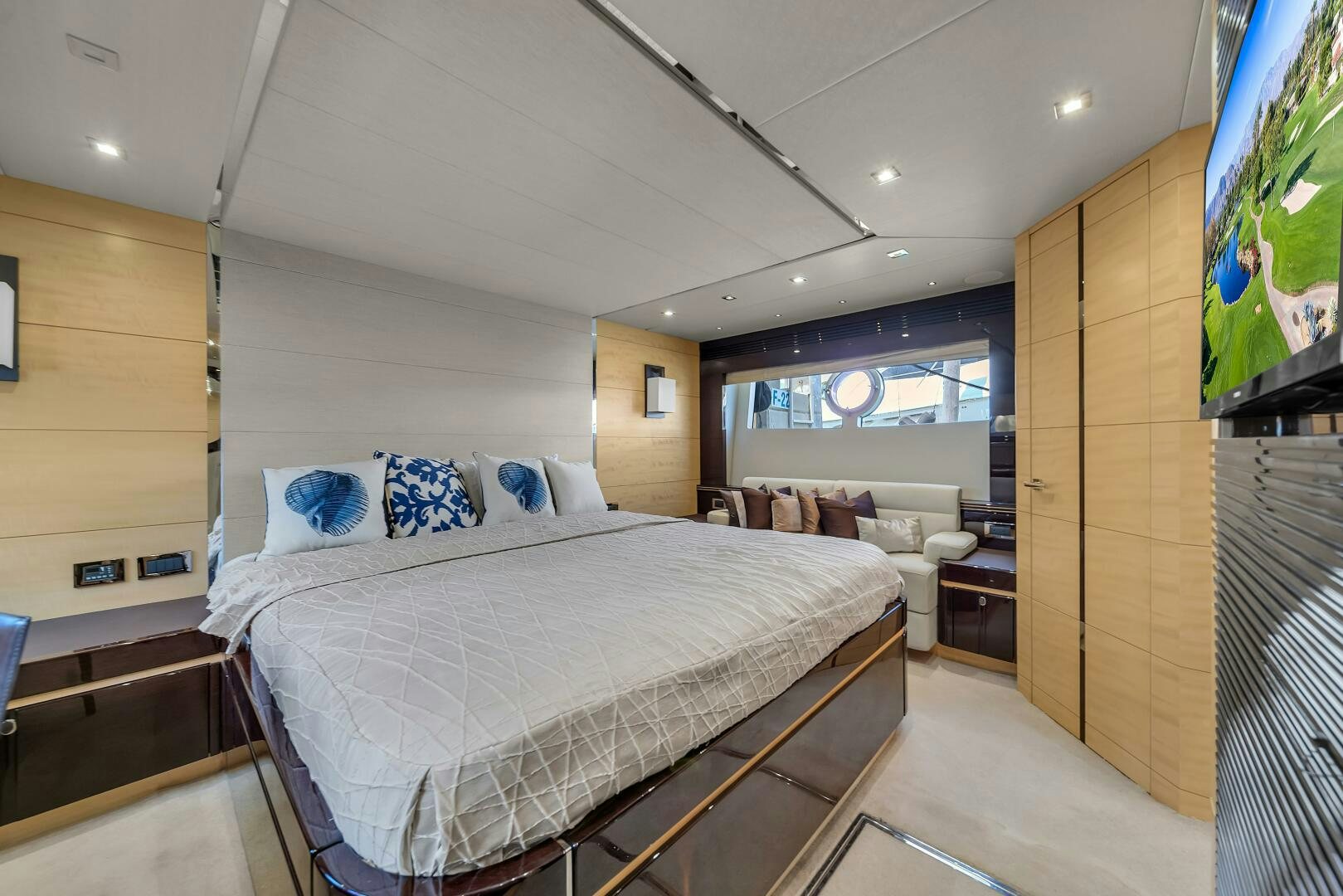 a bedroom with a bed and a tv aboard GEM Yacht for Sale