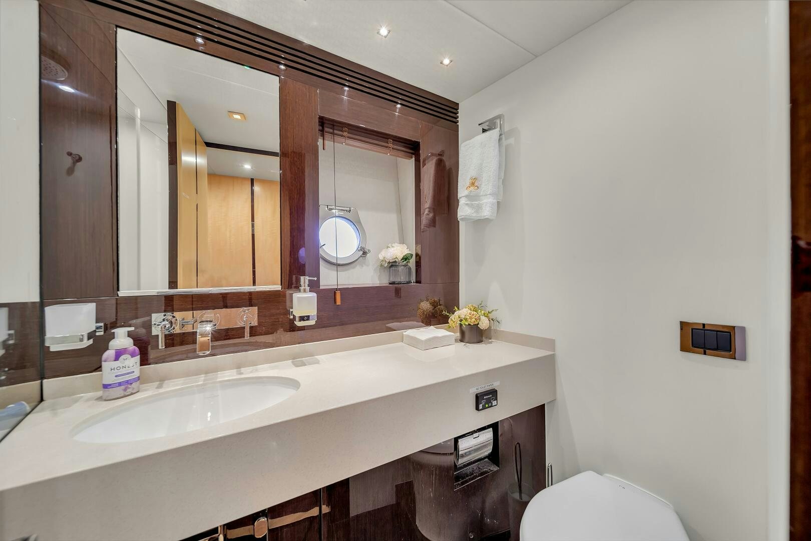 a bathroom with a large mirror aboard GEM Yacht for Sale