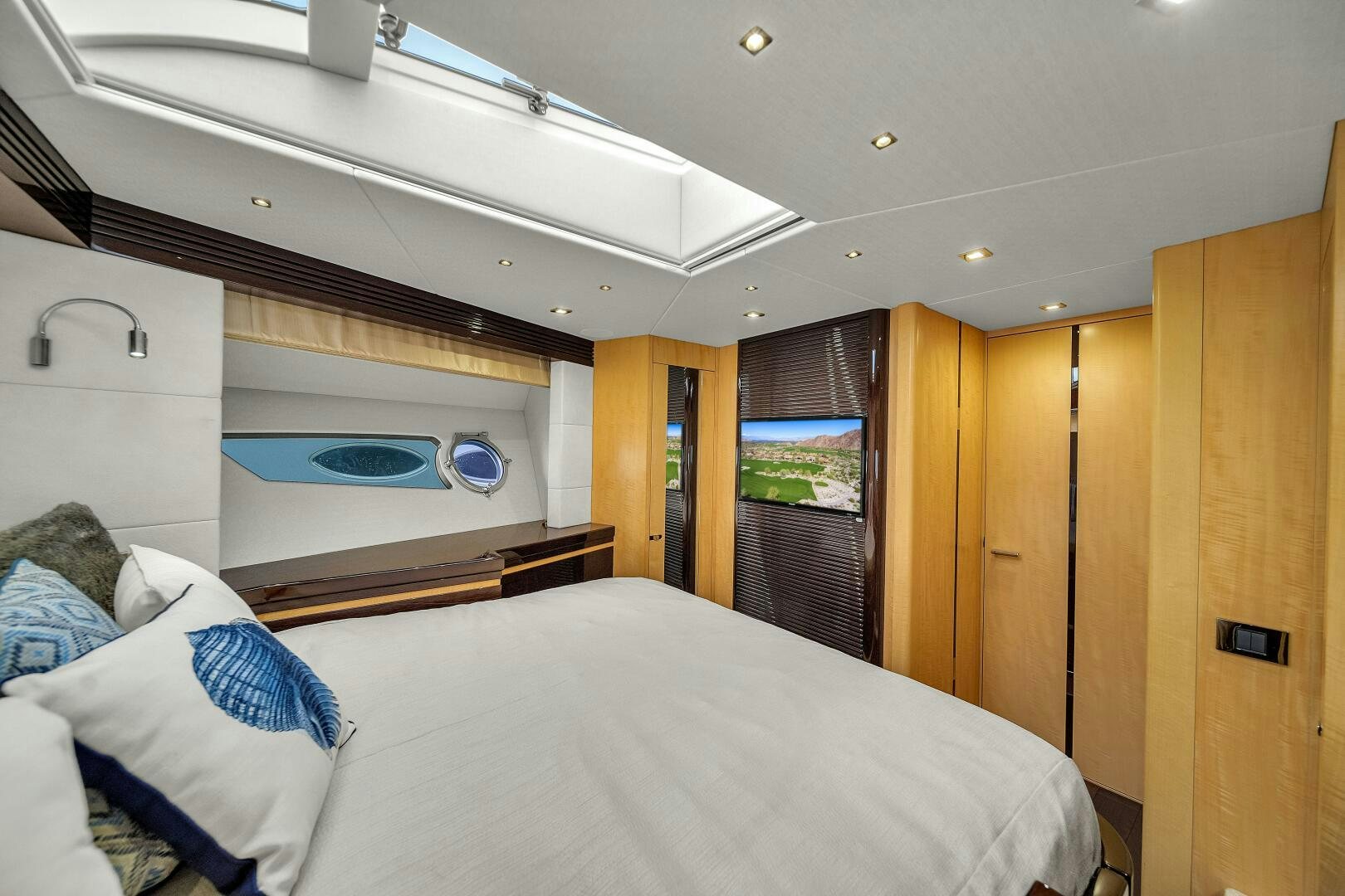 a bedroom with a bed and a television aboard GEM Yacht for Sale