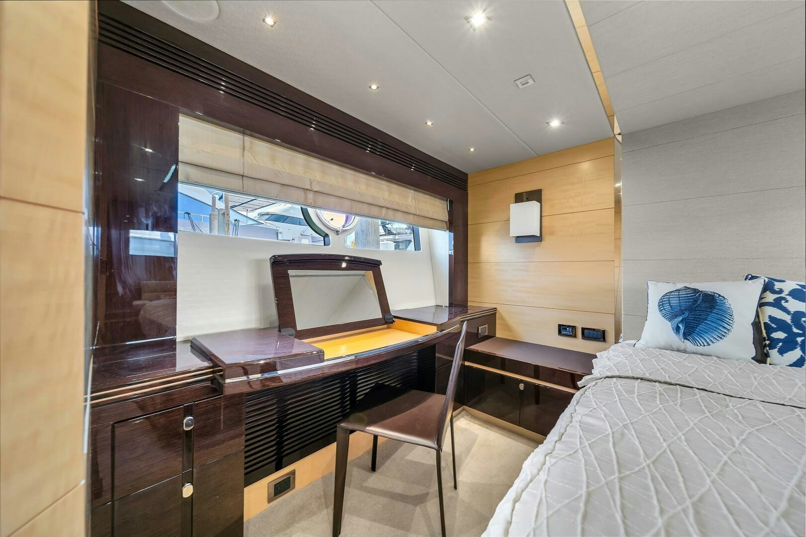 a bedroom with a bed and desk aboard GEM Yacht for Sale