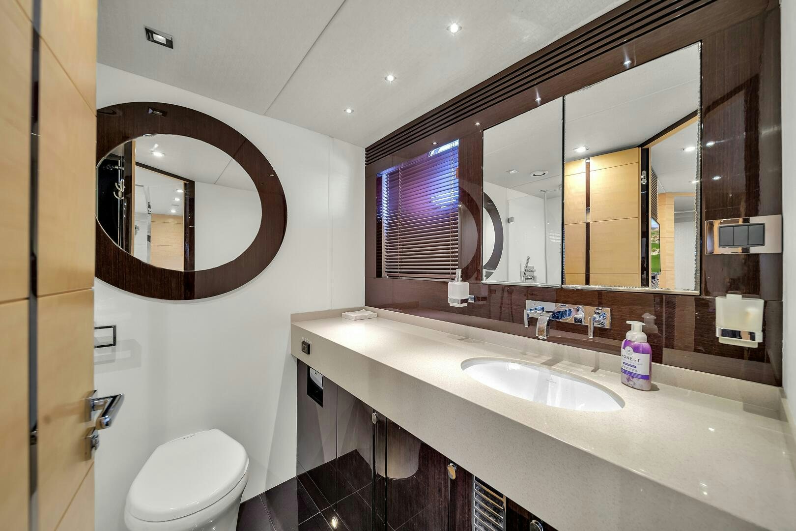 a bathroom with a large mirror aboard GEM Yacht for Sale