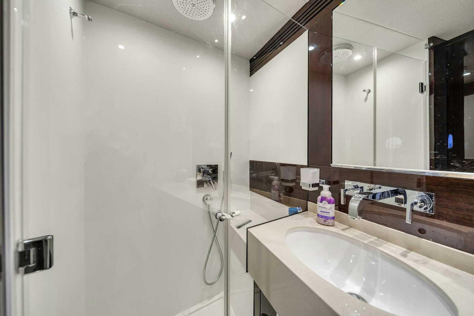 a bathroom with a large mirror aboard GEM Yacht for Sale