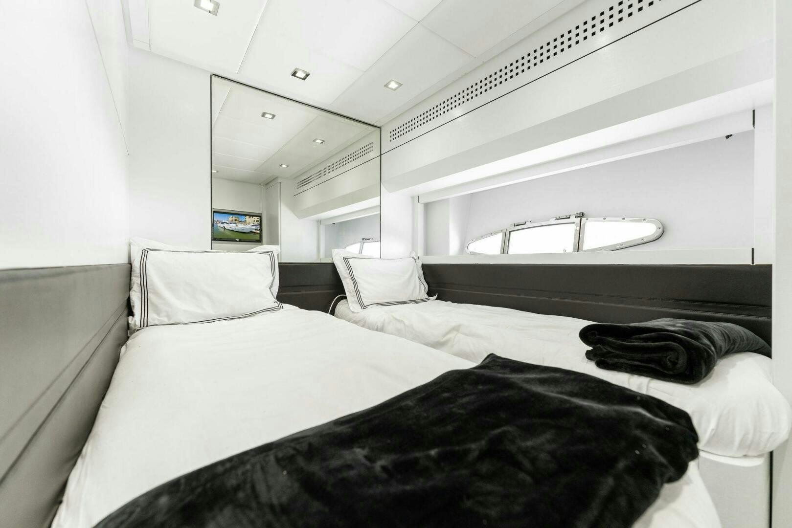 a room with a bed and a window aboard HAWK Yacht for Sale