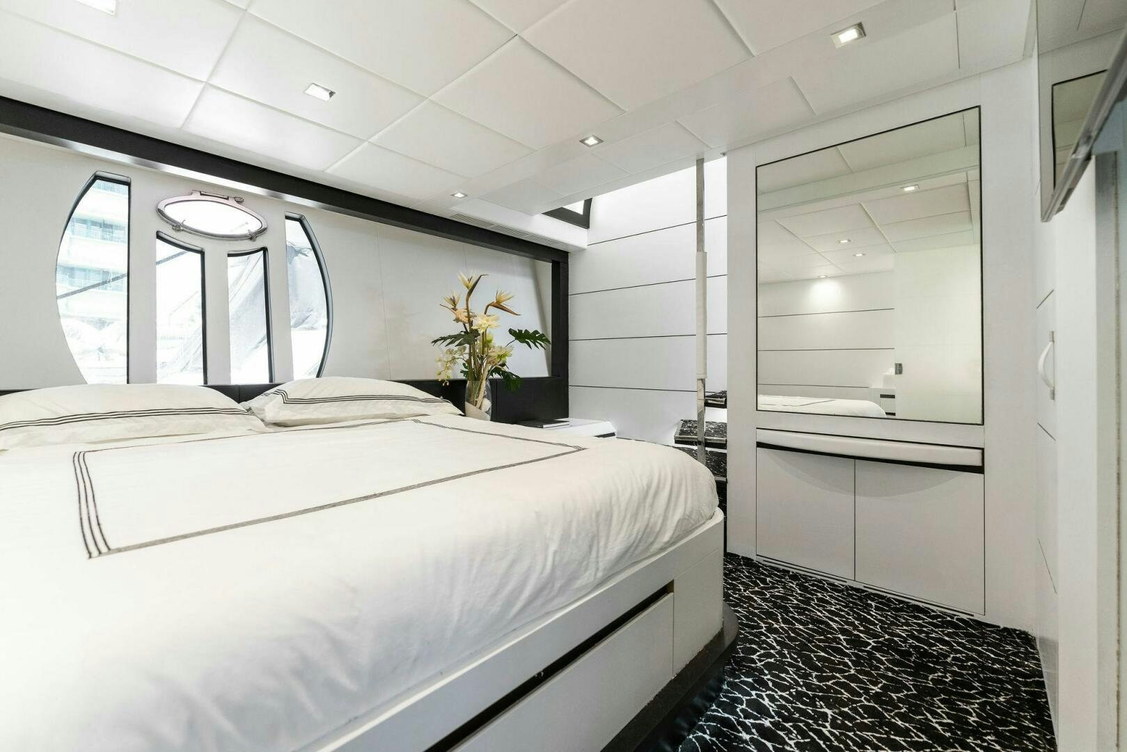 a room with a bed and a window aboard HAWK Yacht for Sale