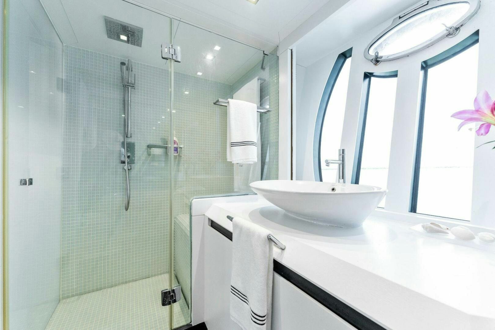 a bathroom with a glass shower aboard HAWK Yacht for Sale