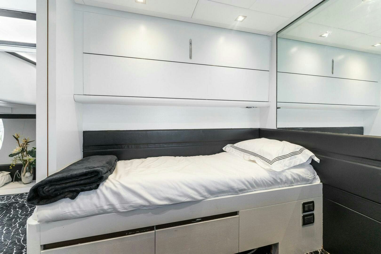 a white bed with a black pillow aboard HAWK Yacht for Sale