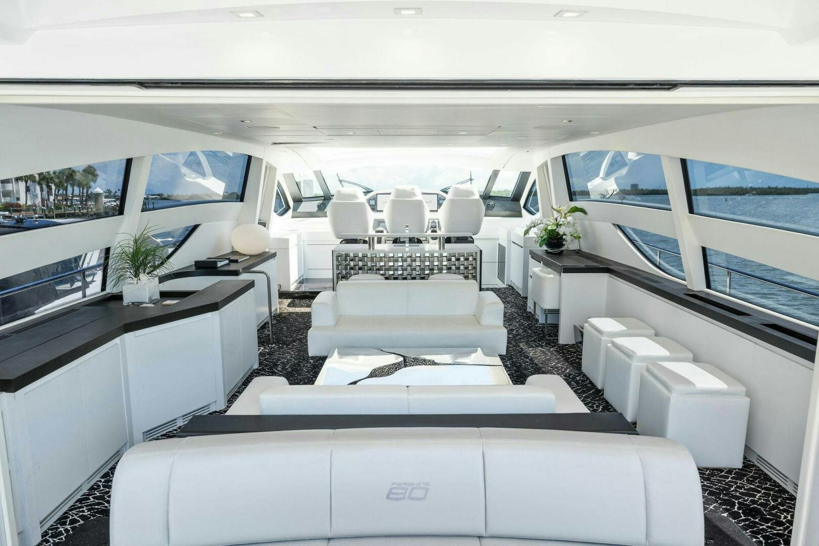 a room with white couches aboard HAWK Yacht for Sale