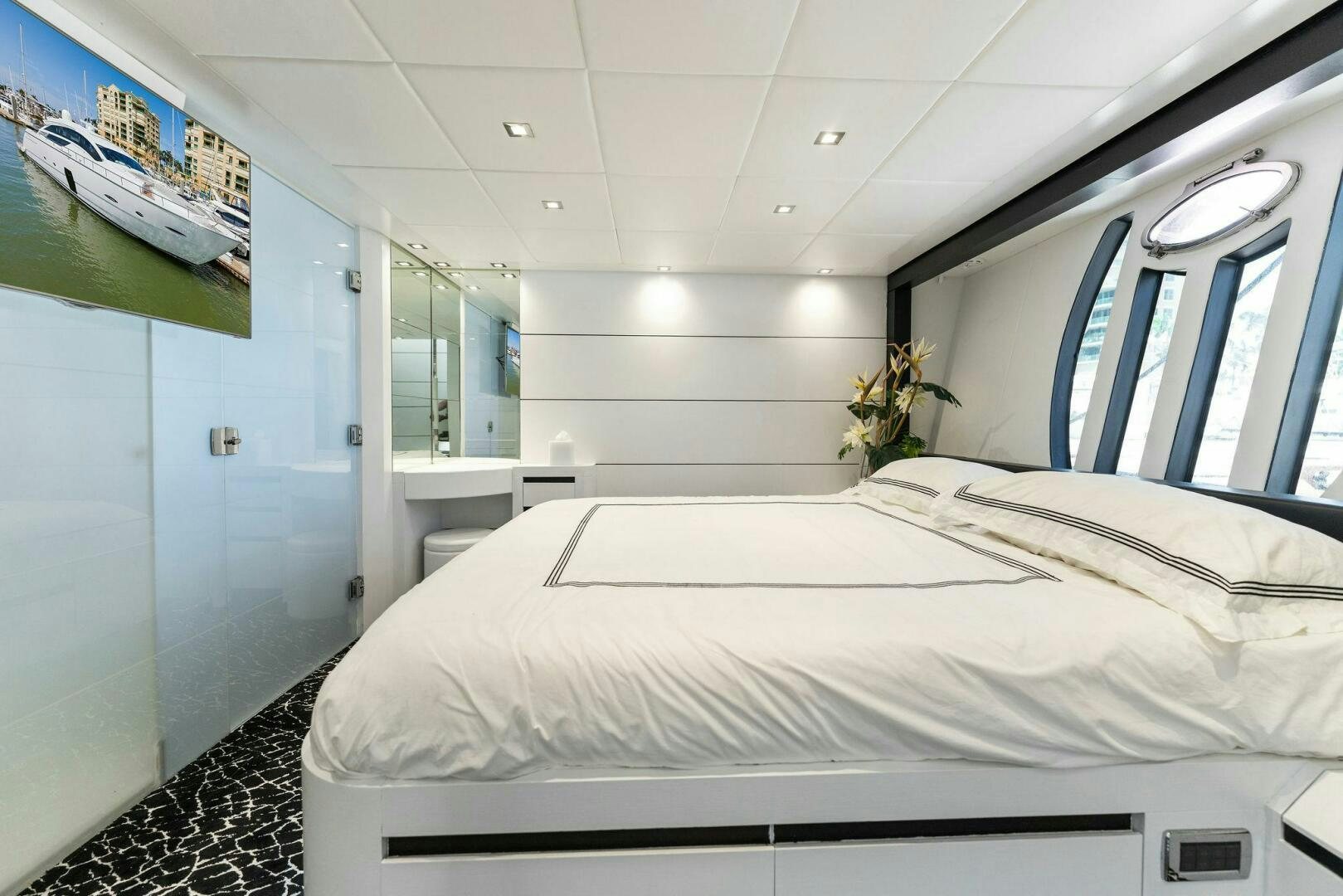 a room with a bed and a window aboard HAWK Yacht for Sale