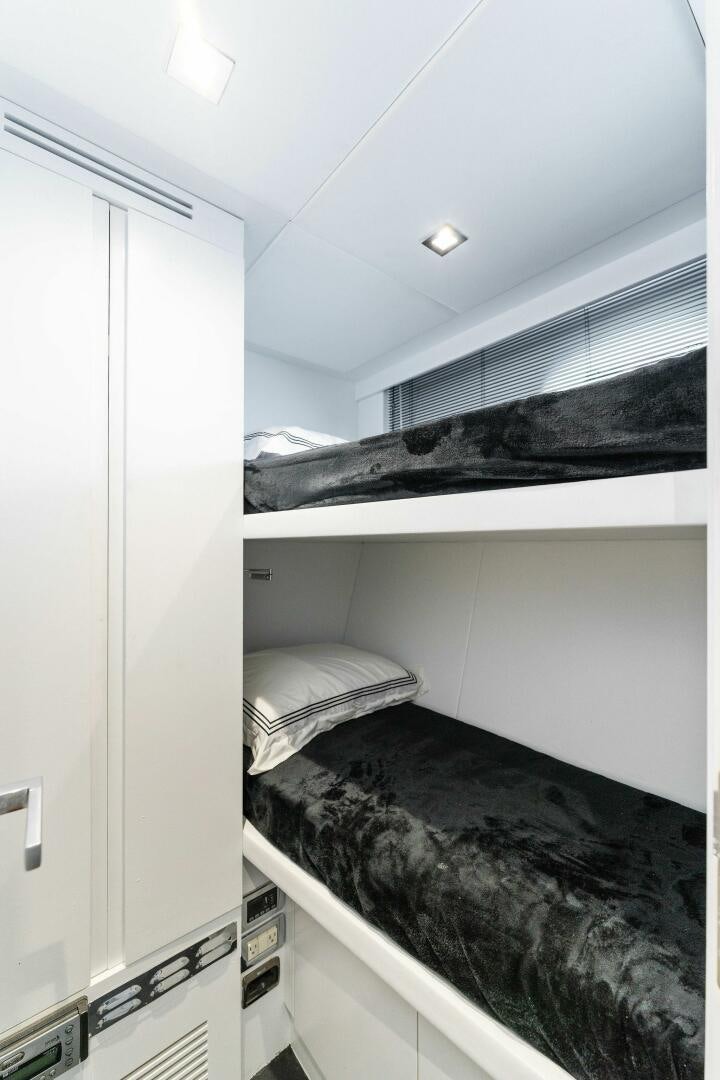 a room with a bed and a black rug aboard HAWK Yacht for Sale