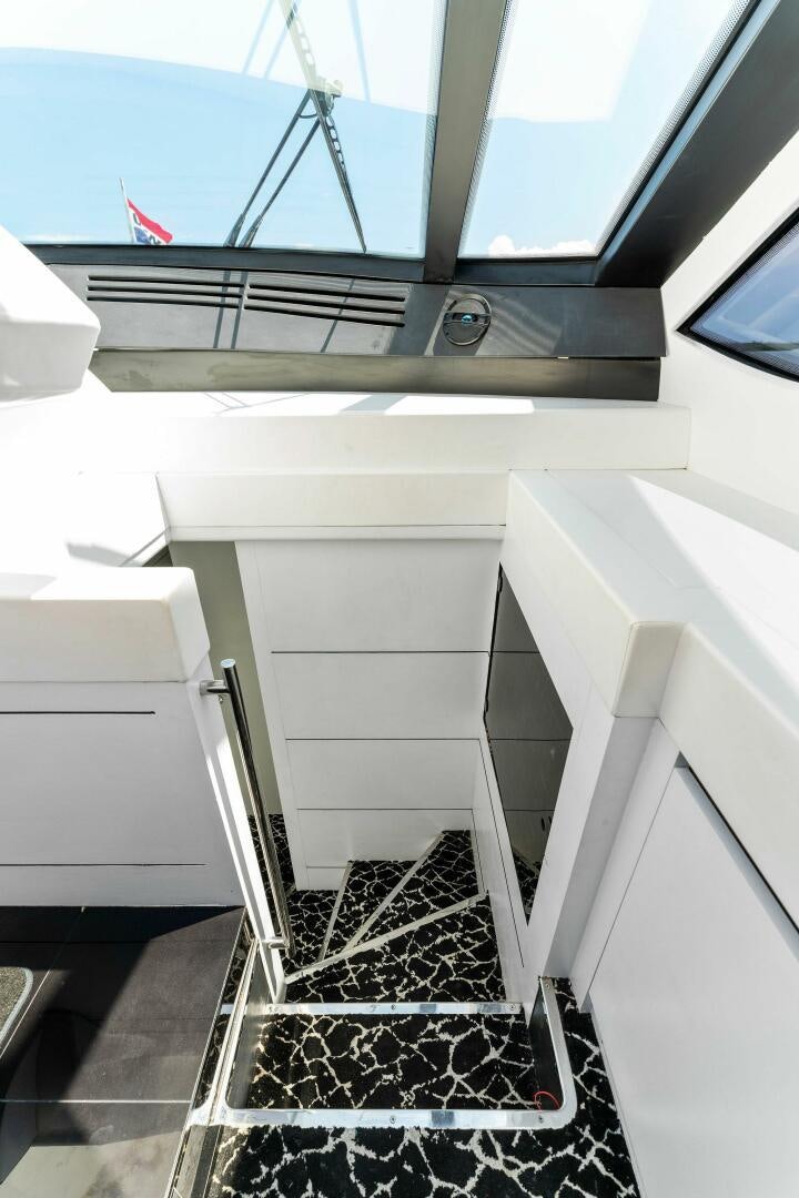 a white staircase with a red flag aboard HAWK Yacht for Sale