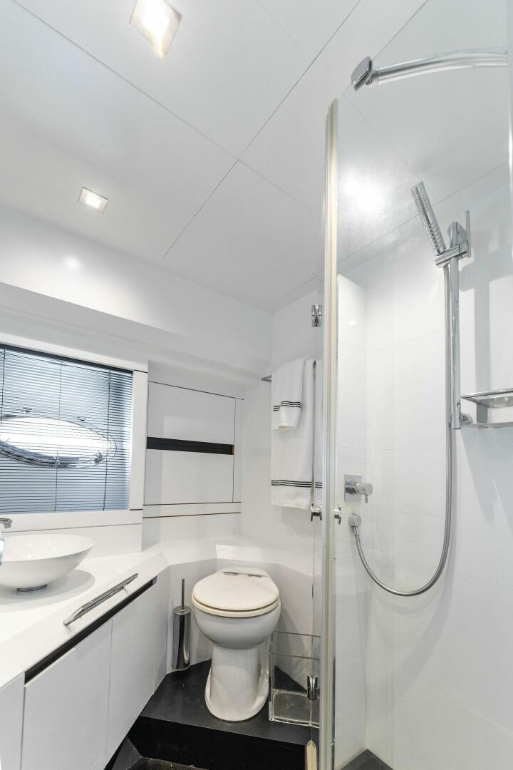a bathroom with a glass shower aboard HAWK Yacht for Sale