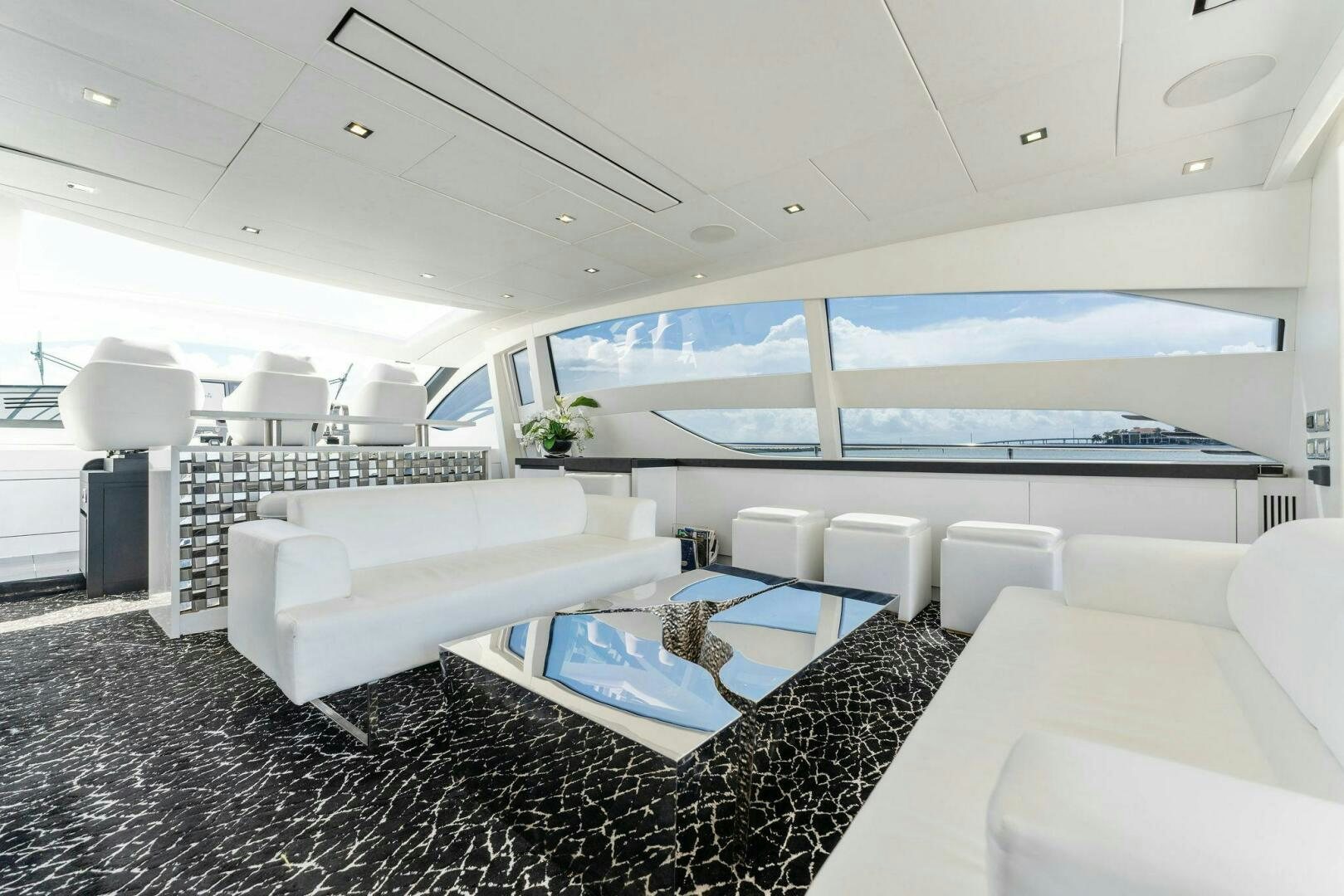 a room with a large window and a large white sofa aboard HAWK Yacht for Sale