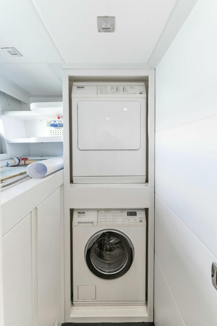a white laundry room aboard HAWK Yacht for Sale