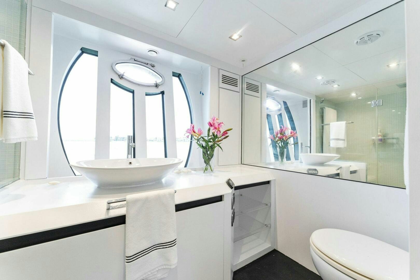 a bathroom with a large mirror aboard HAWK Yacht for Sale