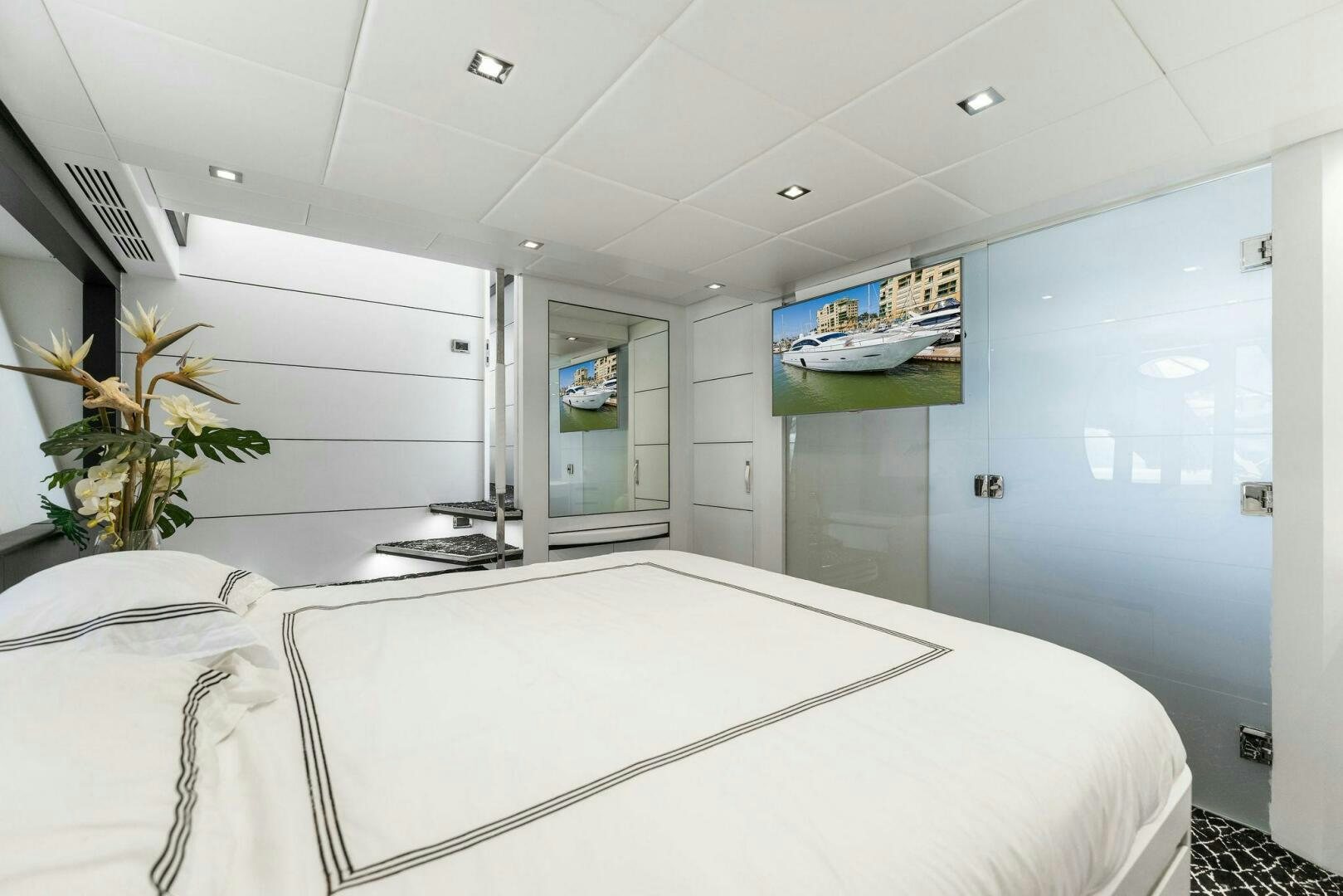 a large white room with a large white table and chairs aboard HAWK Yacht for Sale