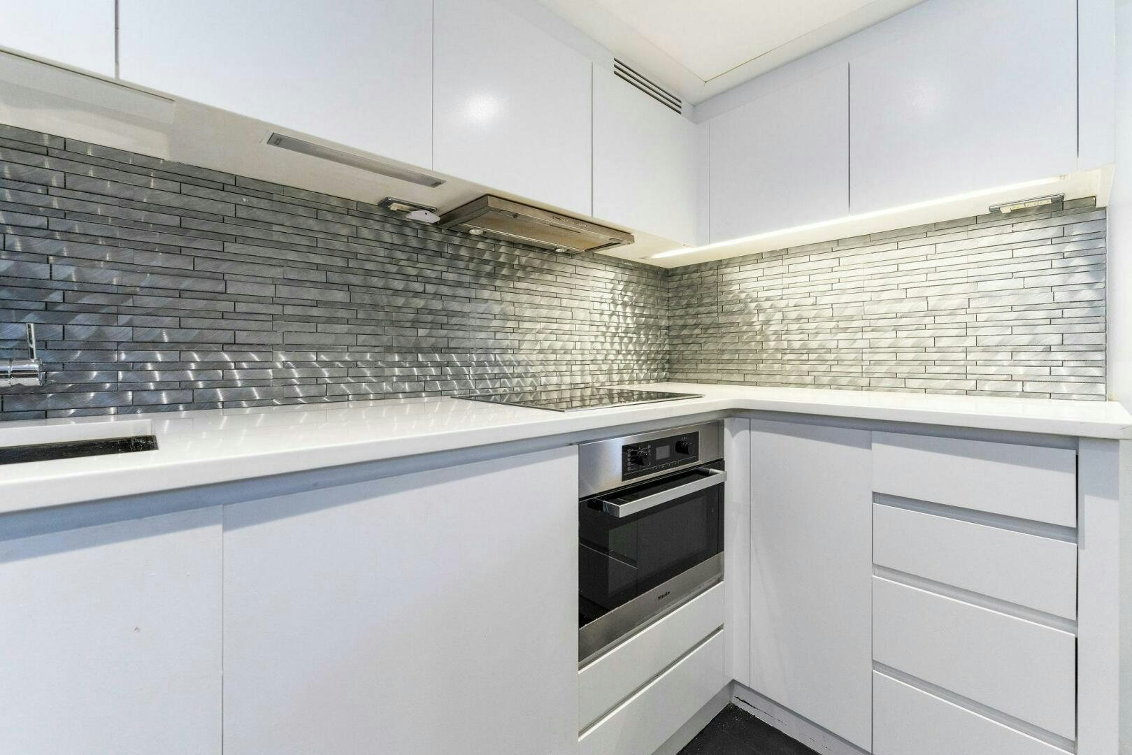 a kitchen with white cabinets aboard HAWK Yacht for Sale