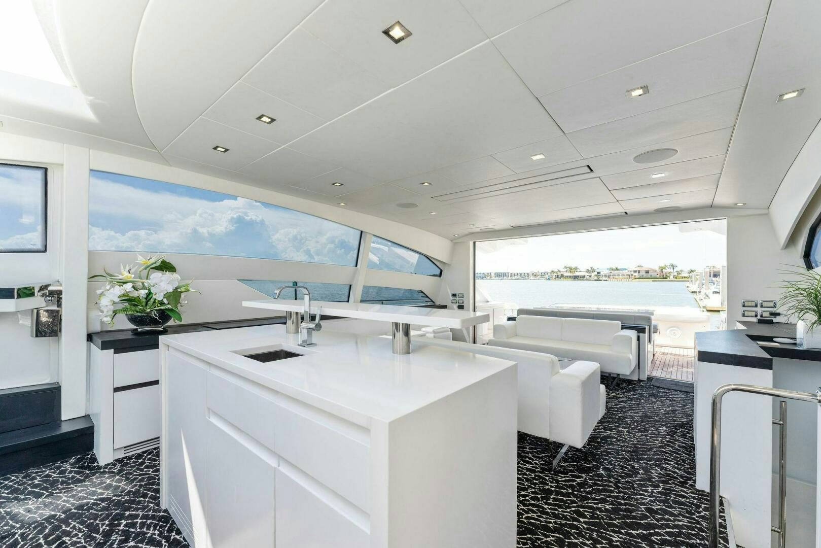 a white kitchen with a large island aboard HAWK Yacht for Sale