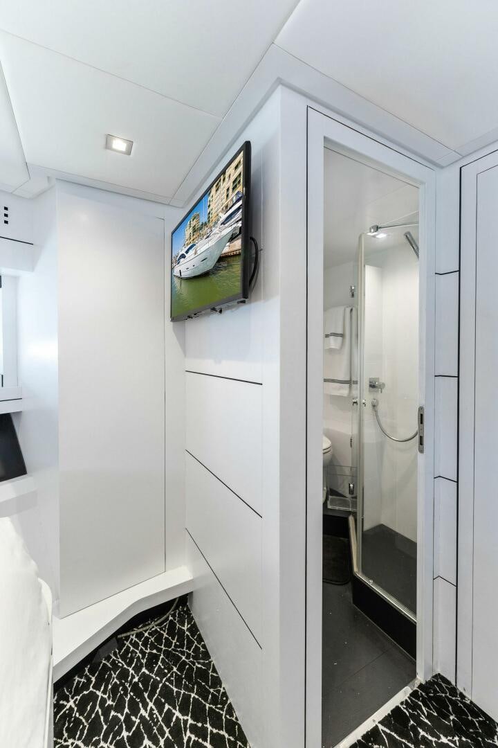 a hallway with a television and a television on the wall aboard HAWK Yacht for Sale