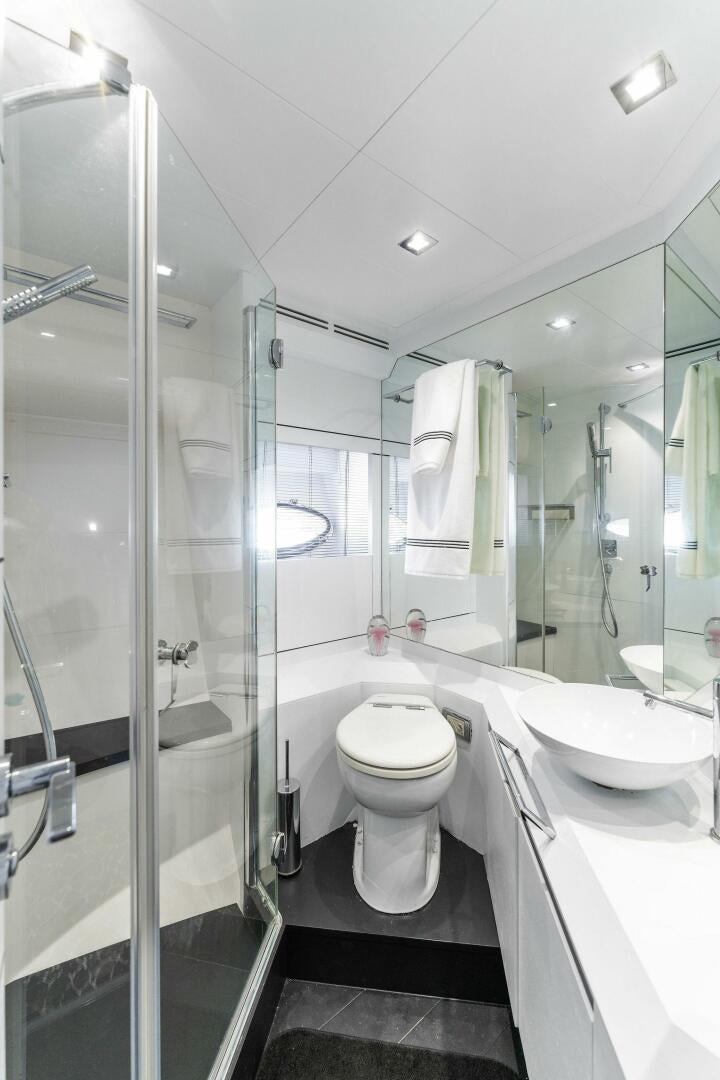 a bathroom with a glass shower aboard HAWK Yacht for Sale