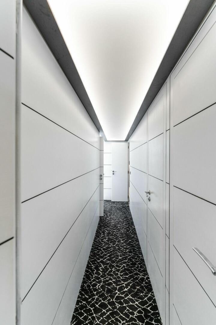 a hallway with white doors aboard HAWK Yacht for Sale
