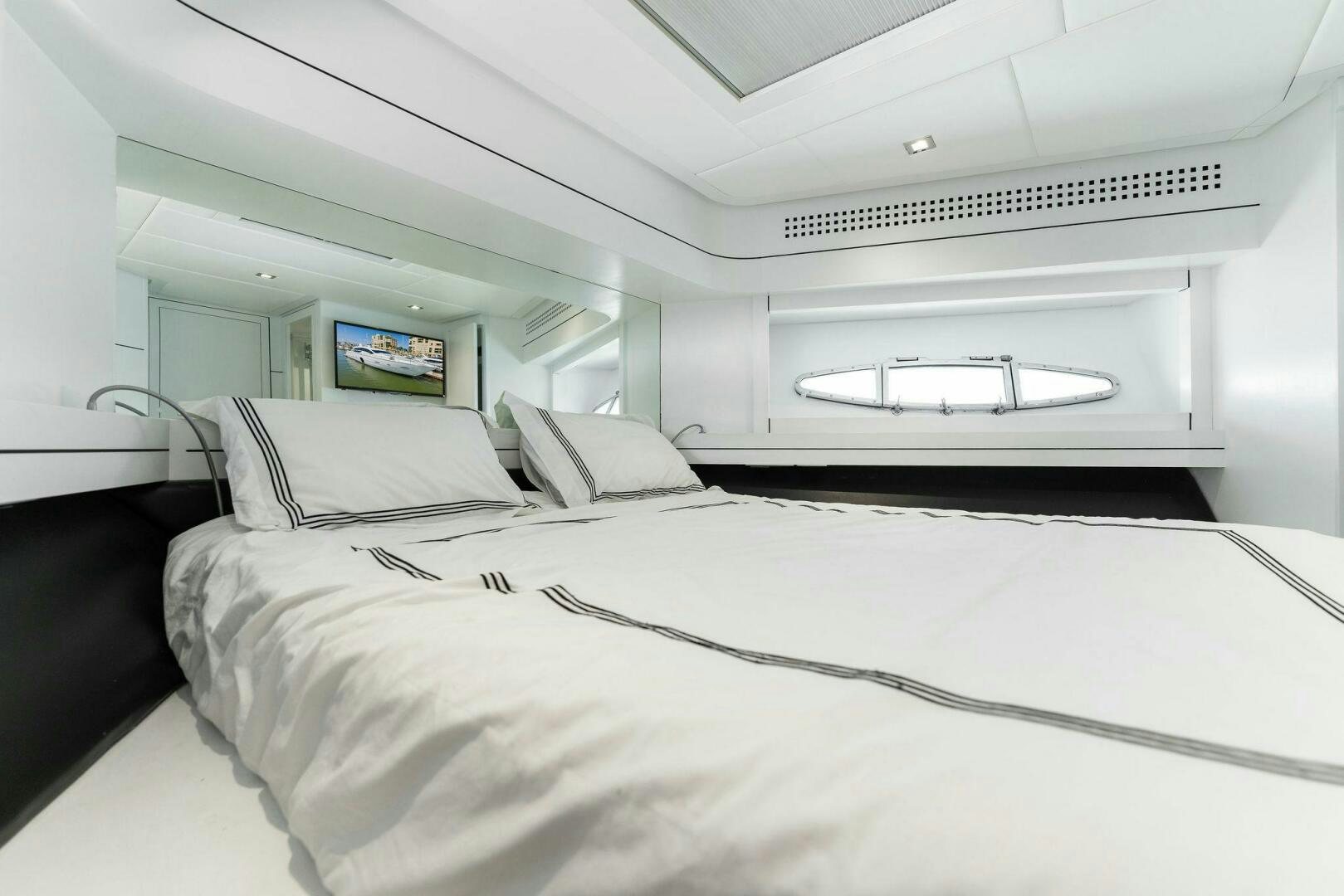 a white bedroom with a bed aboard HAWK Yacht for Sale