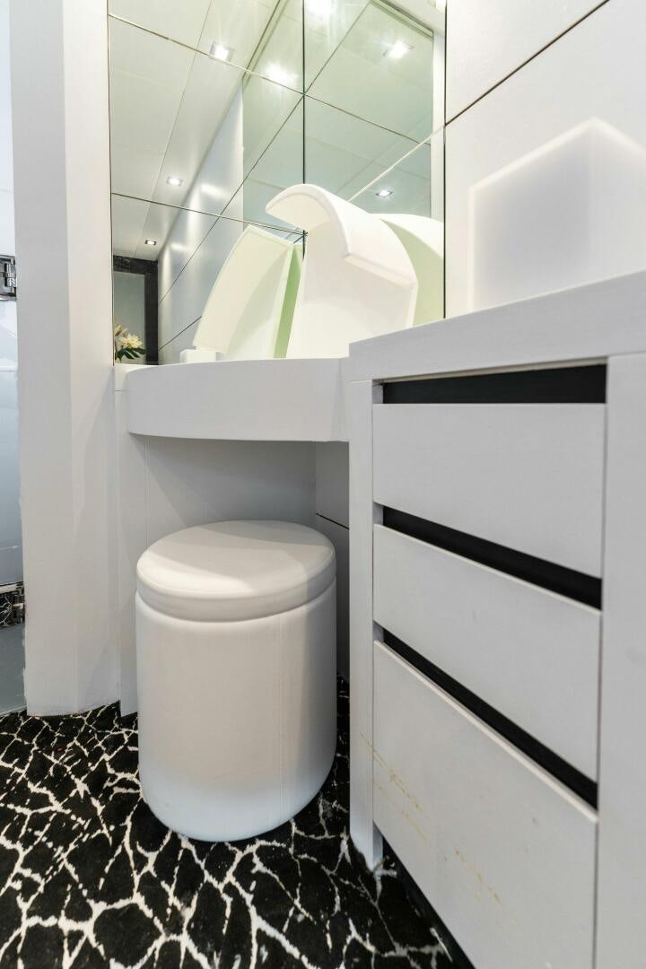 a toilet with a mirror above it aboard HAWK Yacht for Sale