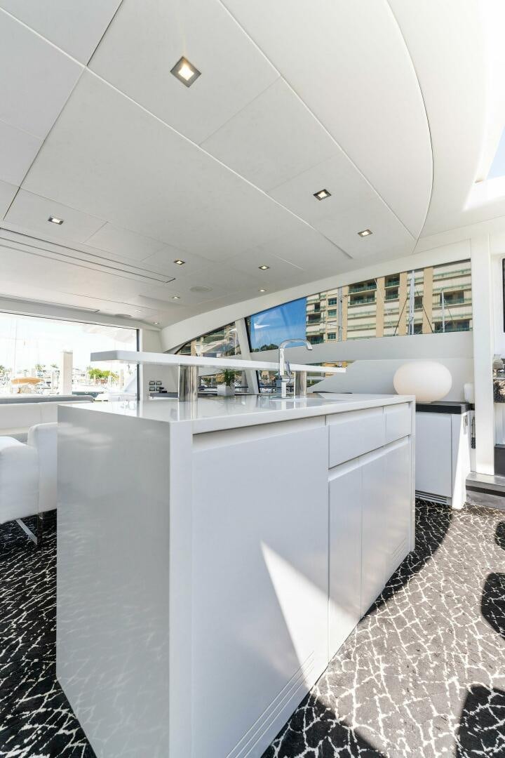a kitchen with white cabinets aboard HAWK Yacht for Sale
