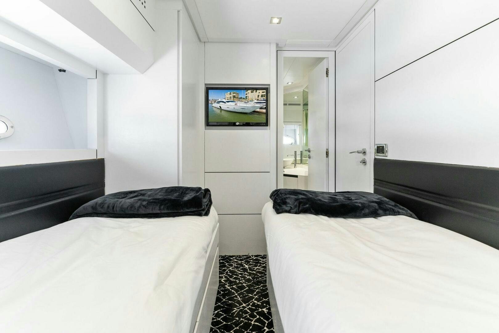 a bedroom with two beds aboard HAWK Yacht for Sale