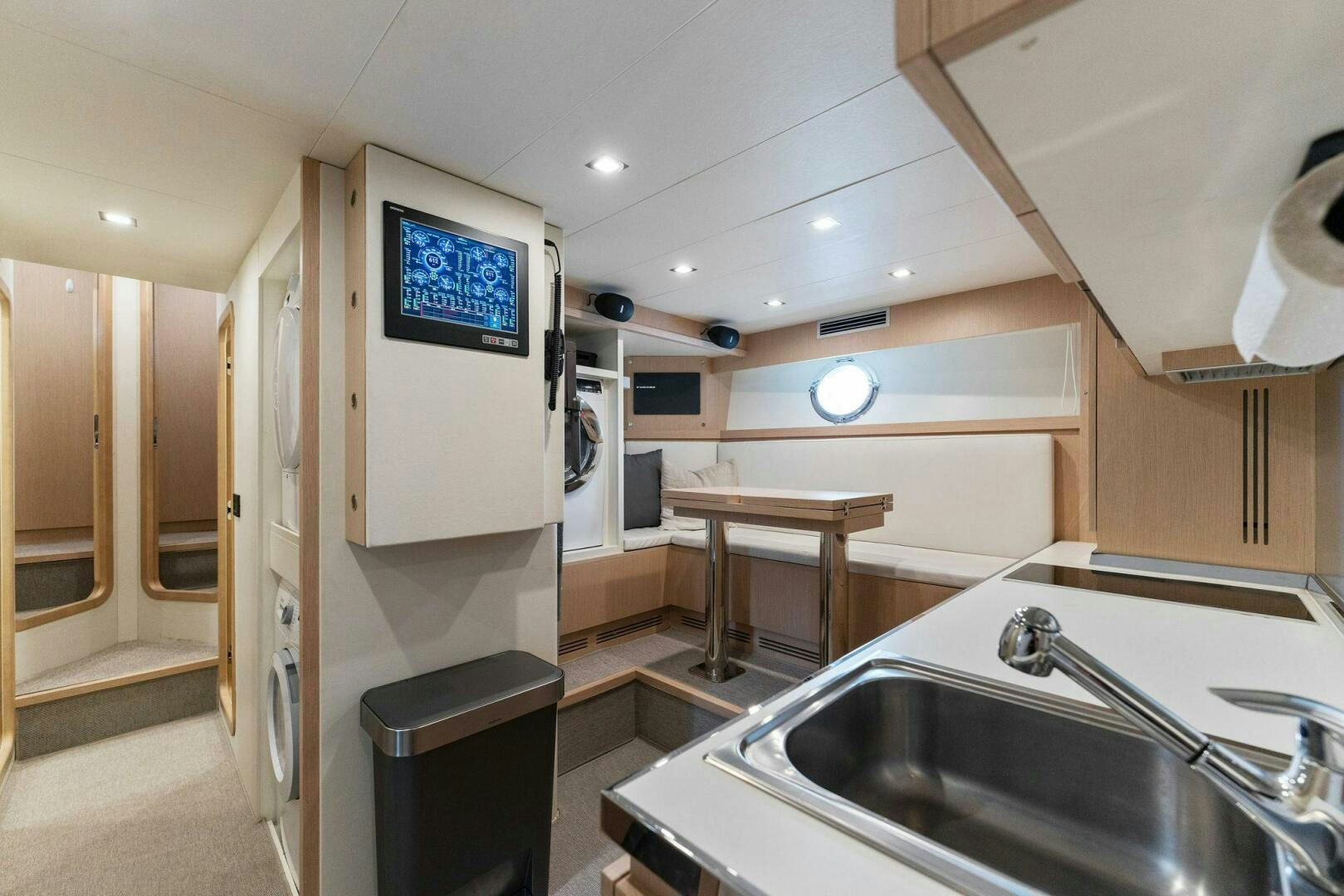 a kitchen with a sink and a tv aboard CHOP CHOP Yacht for Sale