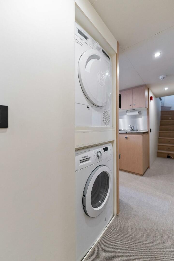 a laundry room with a washing machine aboard CHOP CHOP Yacht for Sale