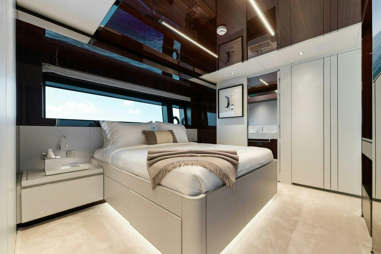 a bedroom with a bed and a desk aboard CHOP CHOP Yacht for Sale