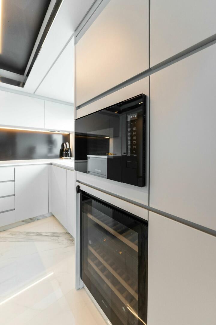 a kitchen with white cabinets aboard CHOP CHOP Yacht for Sale