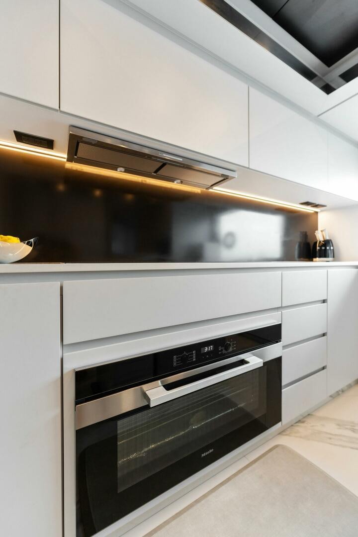 a kitchen with white cabinets aboard CHOP CHOP Yacht for Sale