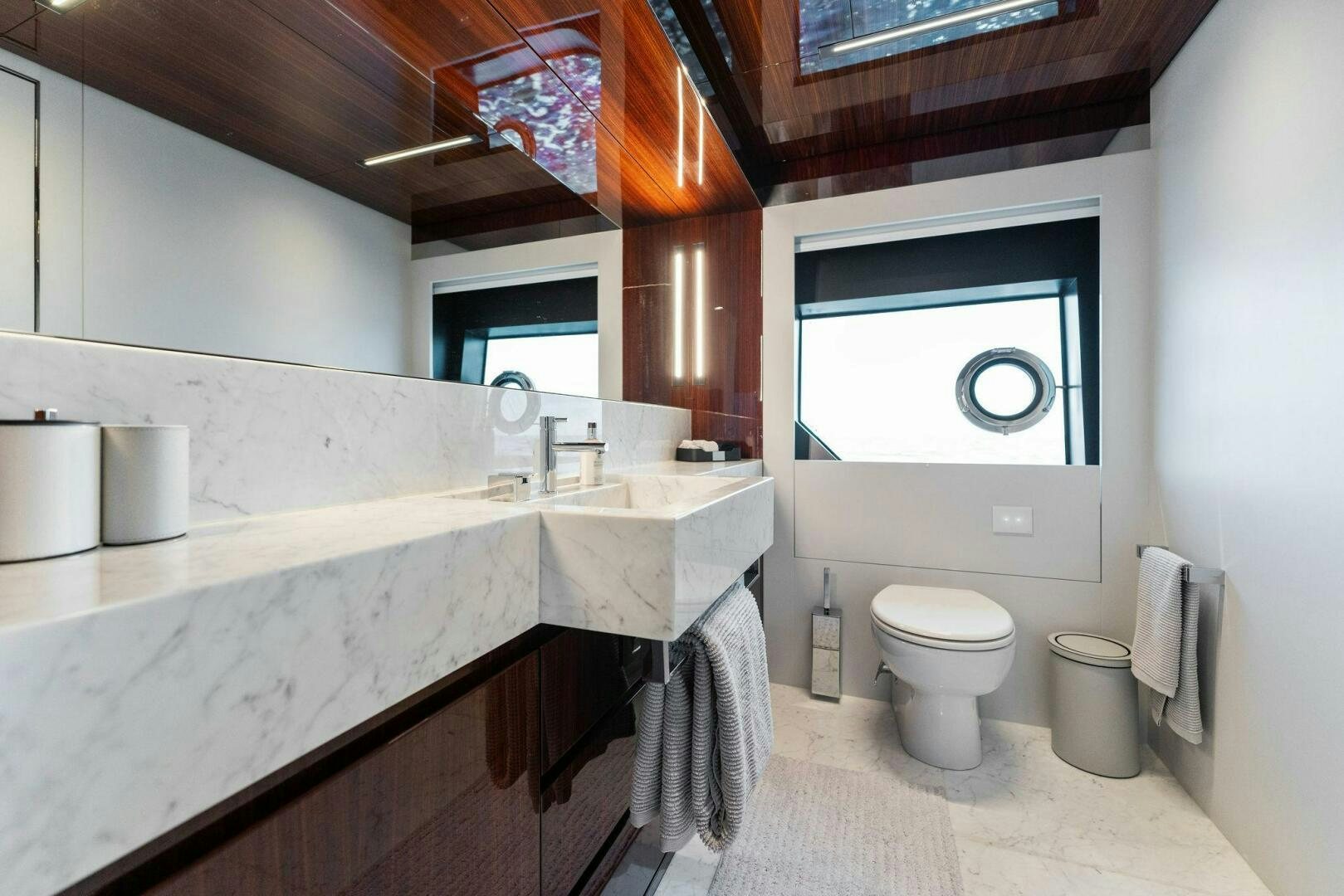 a bathroom with a sink toilet and a window aboard CHOP CHOP Yacht for Sale