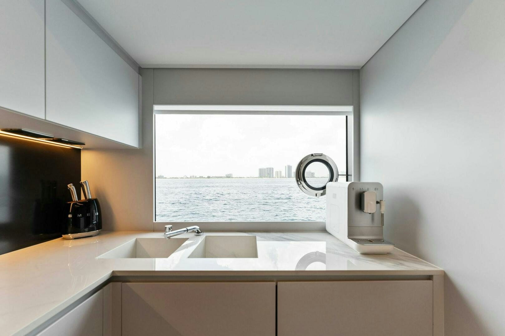 a kitchen with a sink and a window aboard CHOP CHOP Yacht for Sale