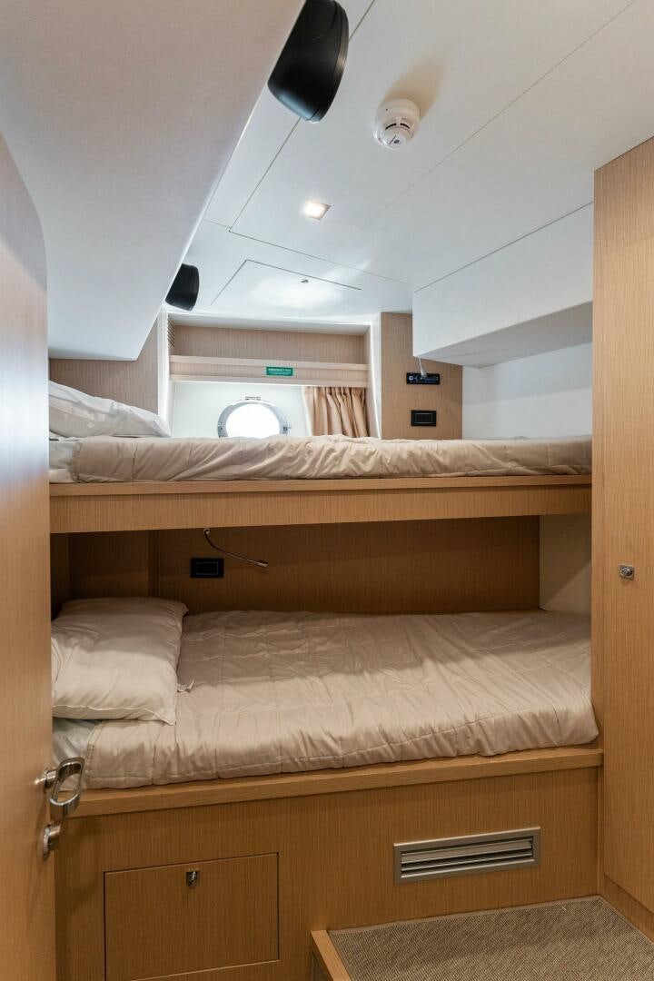a room with a bed and a desk aboard CHOP CHOP Yacht for Sale
