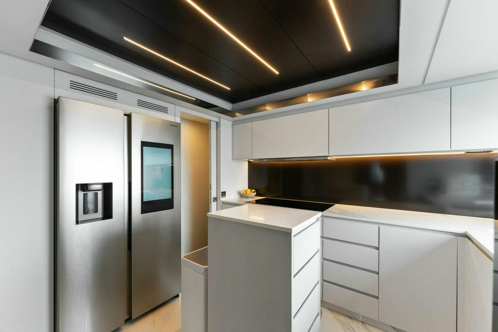 a kitchen with white cabinets aboard CHOP CHOP Yacht for Sale