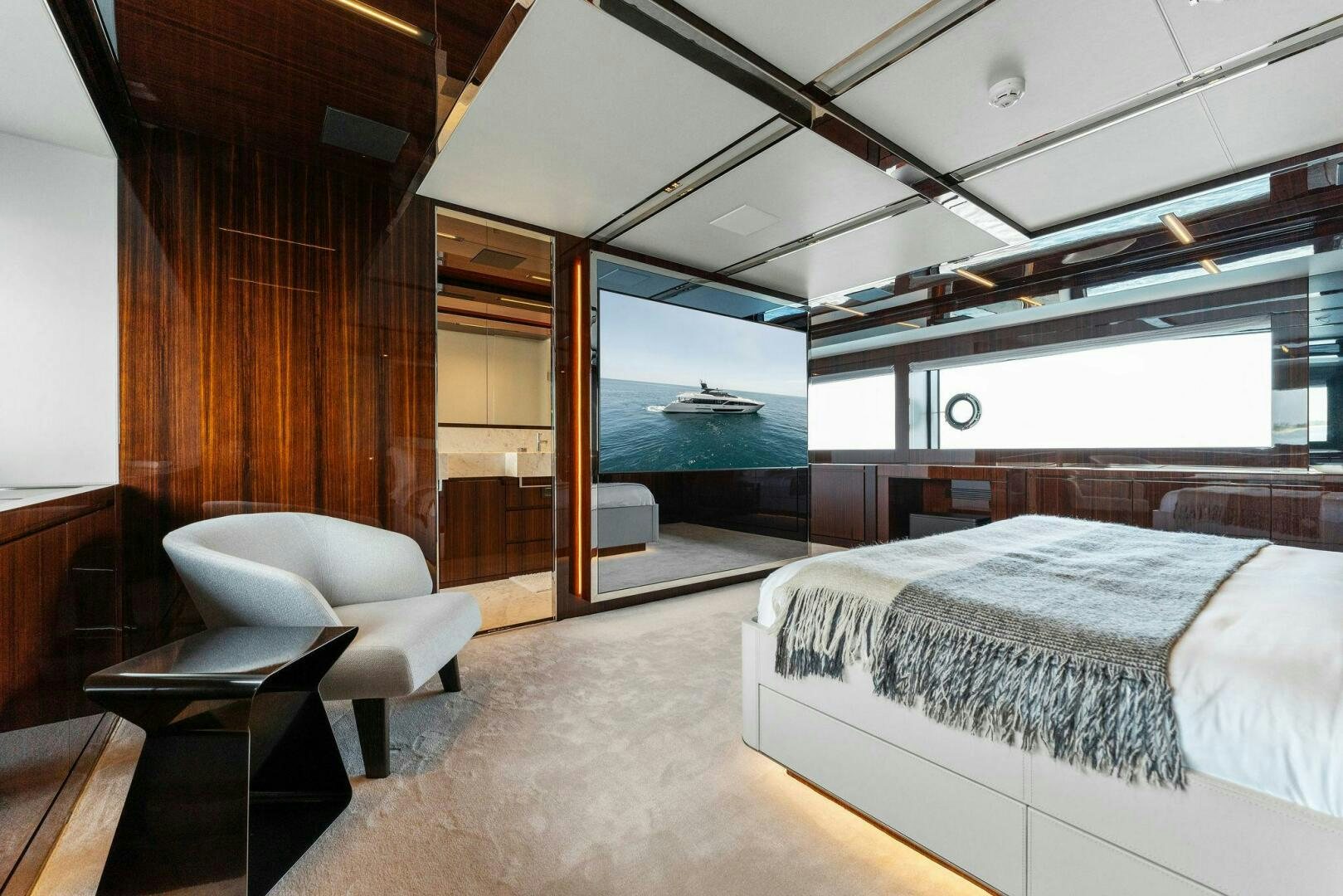 a room with a bed and a chair aboard CHOP CHOP Yacht for Sale